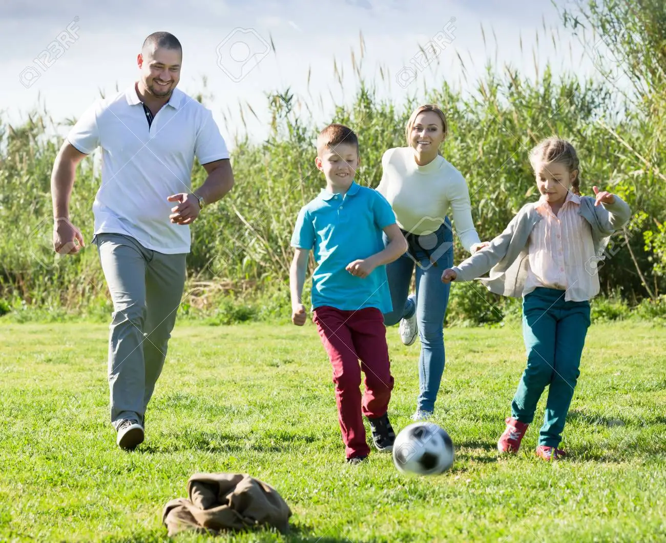 Dad playing soccer with his kids